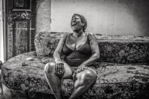 Cuba, Havanna, Woman sitting on sofa and laughing, Life can be funny, Cuba, Havanna, Woman sitting on sofa and laughing, Life can be funny,